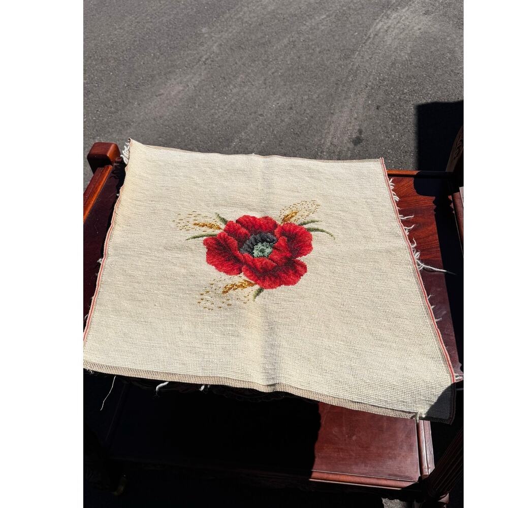 needlepoint canvas vibrant red poppy flower centered on cream-colored background